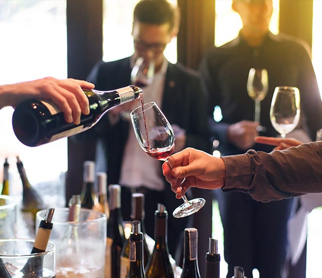 A group of people enjoying a private wine-tasting event at Brix & Mortar restaurant in Vancouver.